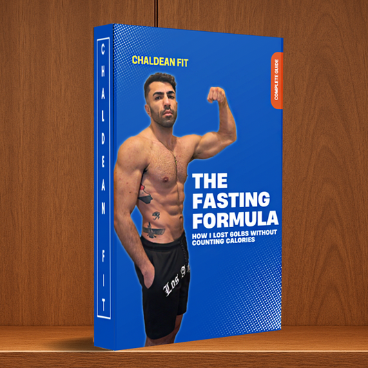 Book titled 'The Fasting Formula' by Chaldean Fit on a wooden surface